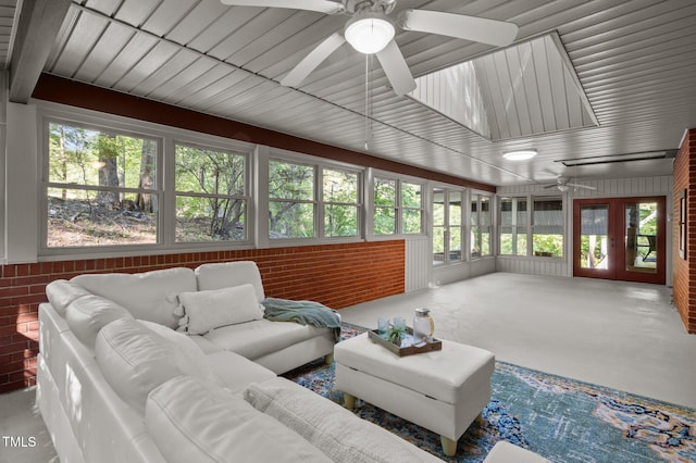 sunroom / solarium featuring french doors and a healthy amount of sunlight