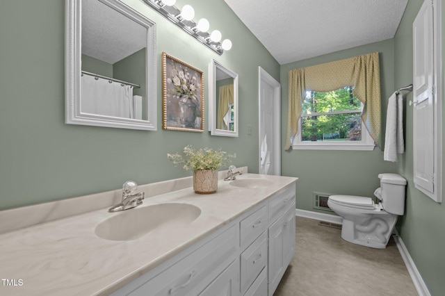 full bath with a sink, baseboards, toilet, and a textured ceiling