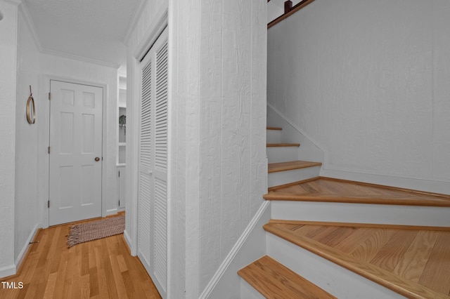 stairway with baseboards and wood finished floors