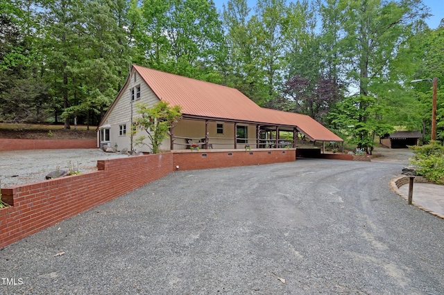 exterior space featuring metal roof and aphalt driveway