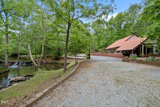 view of street with gravel driveway