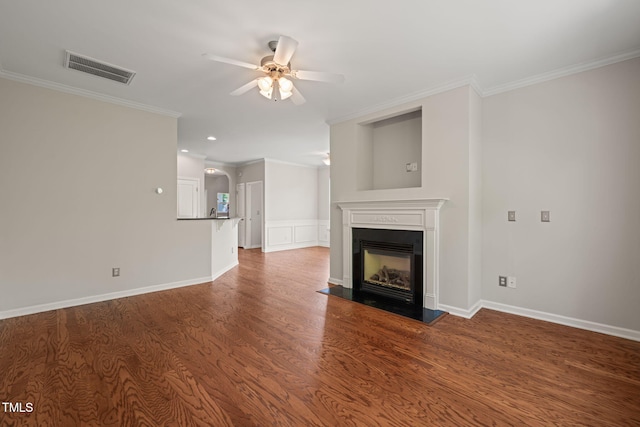 unfurnished living room with visible vents, a ceiling fan, crown molding, and a fireplace