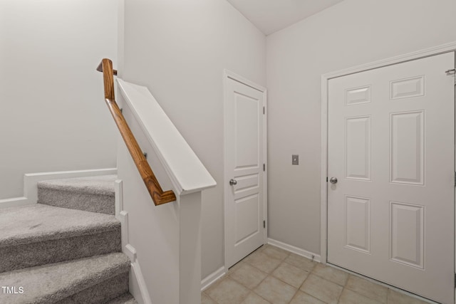 interior space featuring baseboards and stairs