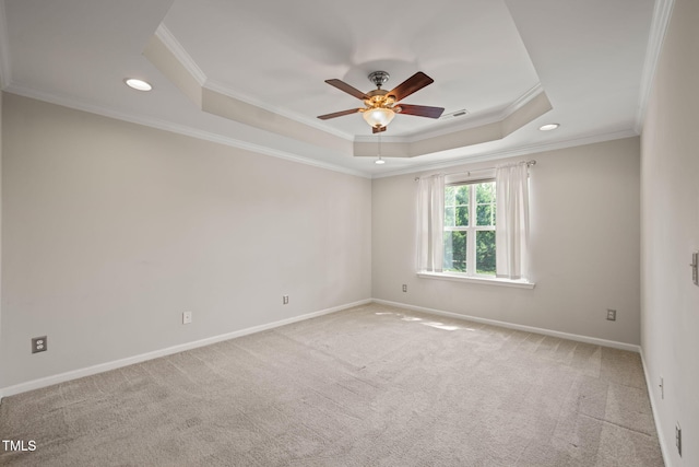 carpeted empty room with crown molding, a ceiling fan, recessed lighting, and a raised ceiling