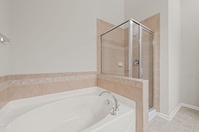 bathroom with a stall shower and a garden tub