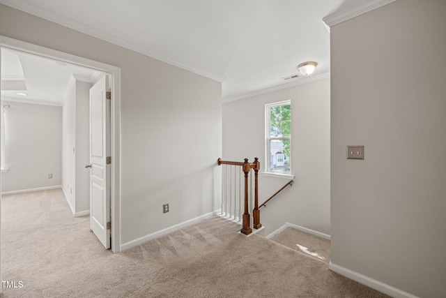 hallway with visible vents, carpet floors, baseboards, an upstairs landing, and ornamental molding