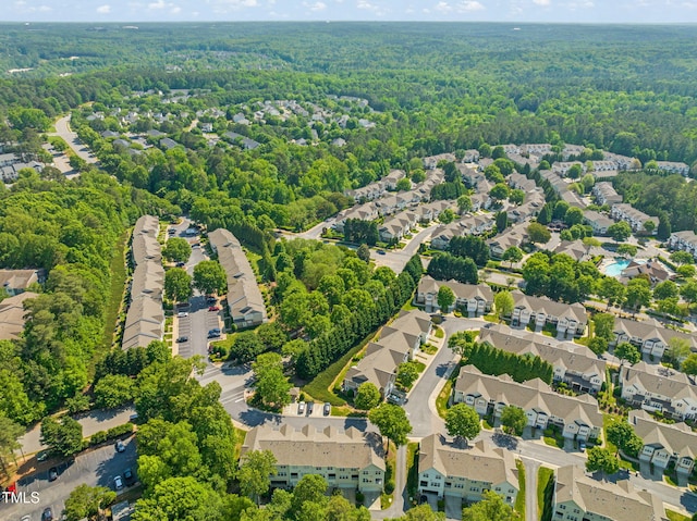 aerial view featuring a forest view and a residential view