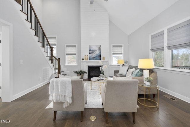 277 High Ridge Ln, Pittsboro, NC 27312 - living area with stairs, high vaulted ceiling, dark wood-type flooring, a large fireplace, and a ceiling fan
