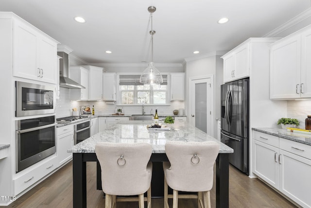 277 High Ridge Ln, Pittsboro, NC 27312 - kitchen with a center island, a sink, ornamental molding, stainless steel appliances, and wall chimney exhaust hood