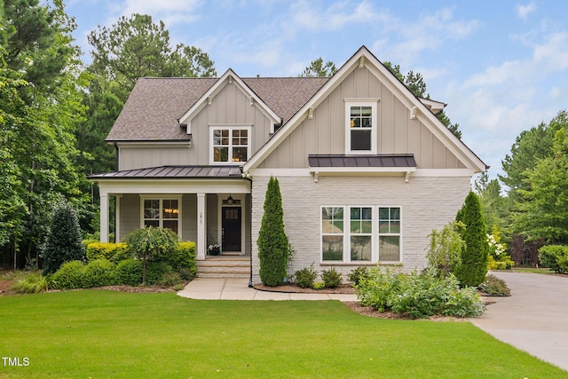 277 High Ridge Ln, Pittsboro, NC 27312 - craftsman-style home with a porch, board and batten siding, a front yard, and a standing seam roof
