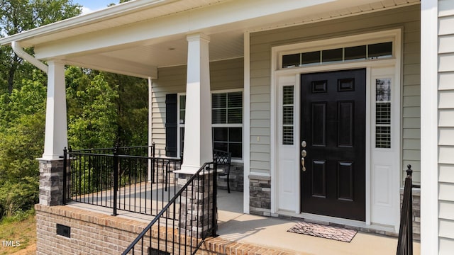 5 Cinnamon Teal Way, Youngsville, NC 27596 - doorway to property featuring covered porch and stone siding