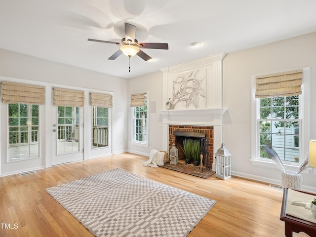 113 Bergeron Way, Cary, NC 27519 - unfurnished living room featuring healthy amount of natural light, ceiling fan, light wood-style floors, and a fireplace