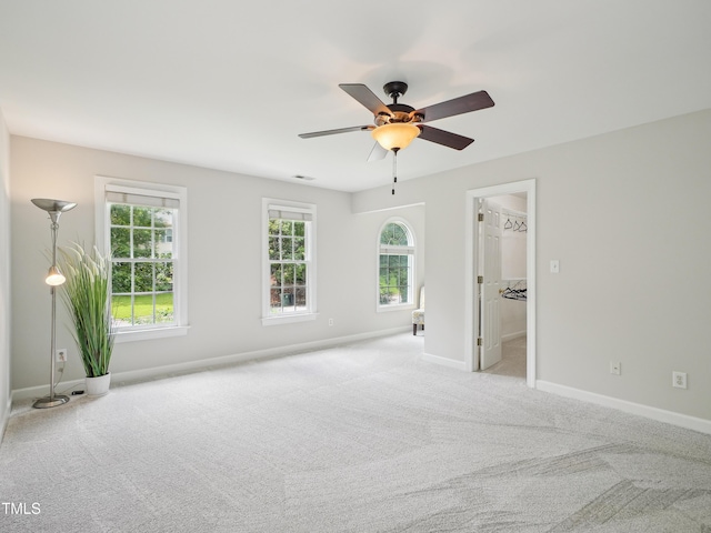 113 Bergeron Way, Cary, NC 27519 - unfurnished bedroom featuring light colored carpet, baseboards, a walk in closet, and a ceiling fan