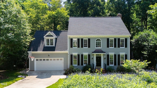 113 Bergeron Way, Cary, NC 27519 - colonial inspired home with concrete driveway, a chimney, and an attached garage