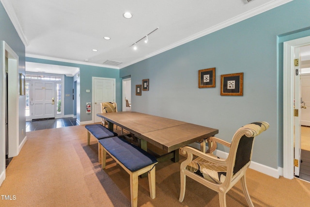 carpeted dining room with crown molding, baseboards, track lighting, and recessed lighting