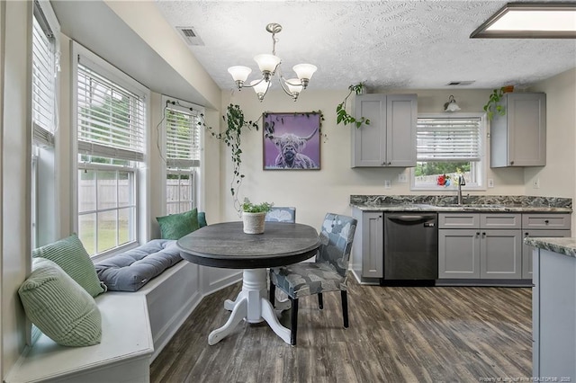 kitchen featuring visible vents, a sink, dishwasher, and gray cabinetry