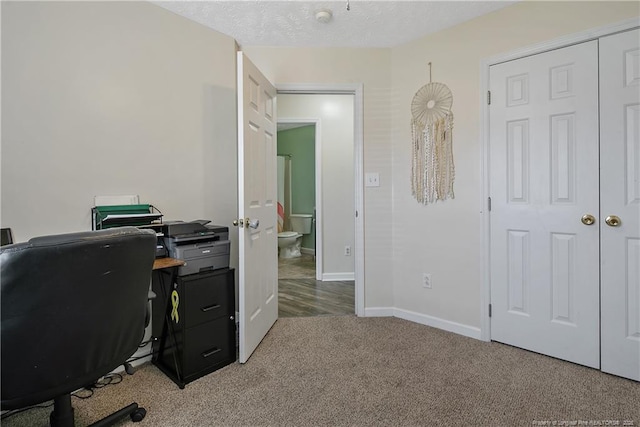 office area featuring baseboards and carpet