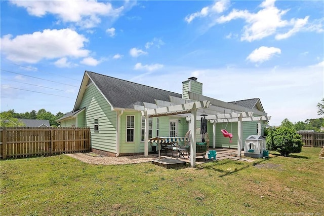 rear view of property featuring a lawn, a pergola, a chimney, and a fenced backyard