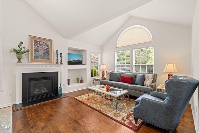 living room with a glass covered fireplace, high vaulted ceiling, built in features, and wood finished floors