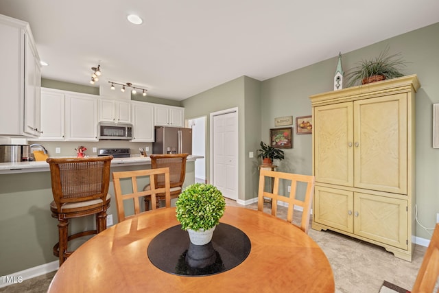 dining space featuring baseboards and recessed lighting