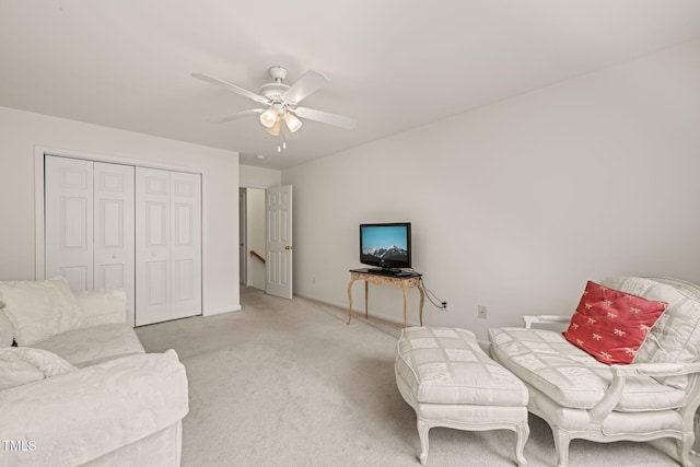 living room featuring a ceiling fan and light carpet