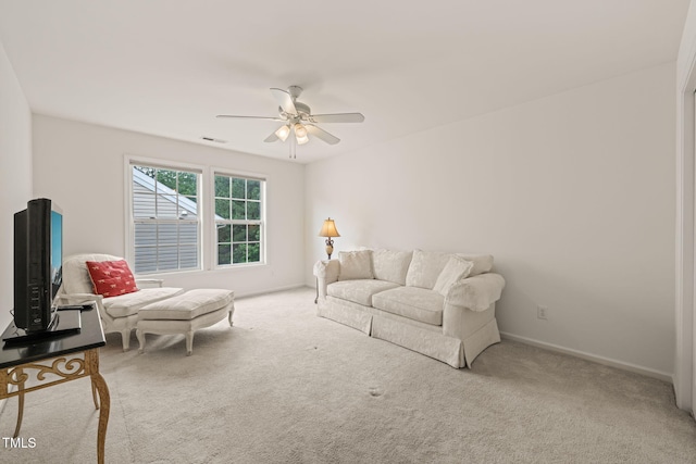 living area featuring baseboards, ceiling fan, visible vents, and carpet floors