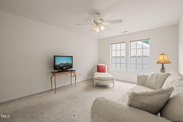 living area featuring ceiling fan, carpet floors, baseboards, and visible vents