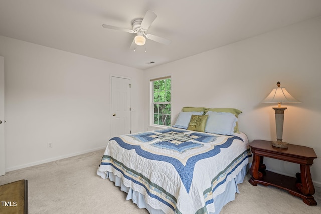 carpeted bedroom with baseboards, visible vents, and a ceiling fan