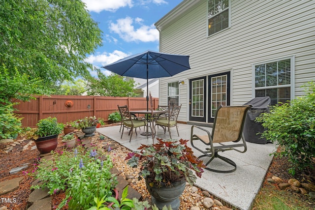 view of patio with grilling area and fence