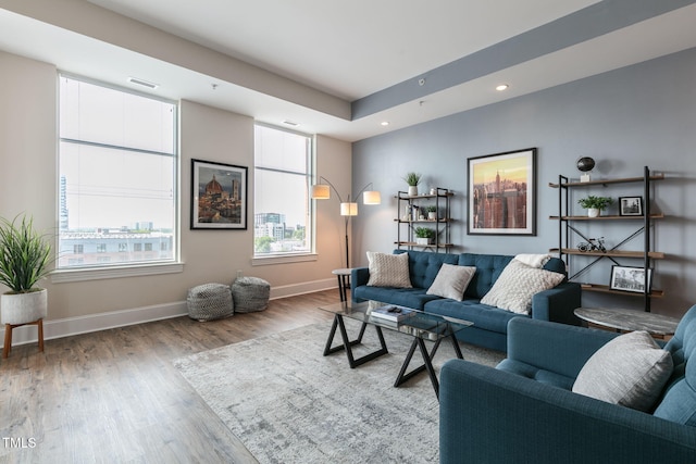 living area with recessed lighting, baseboards, visible vents, and wood finished floors