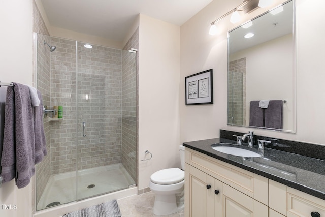 bathroom featuring toilet, a shower stall, tile patterned flooring, and vanity