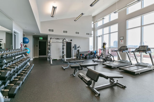 exercise room with a high ceiling and visible vents