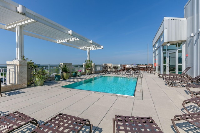 community pool featuring a pergola and a patio