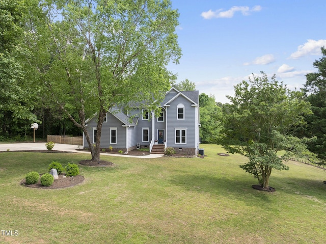 colonial-style house with a front lawn, crawl space, and concrete driveway