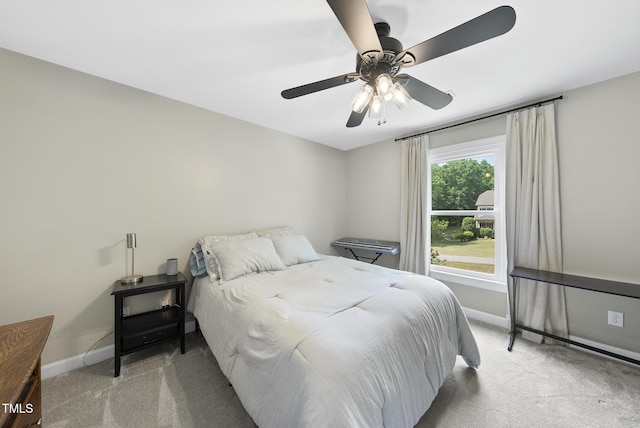 bedroom with baseboards, ceiling fan, and light carpet