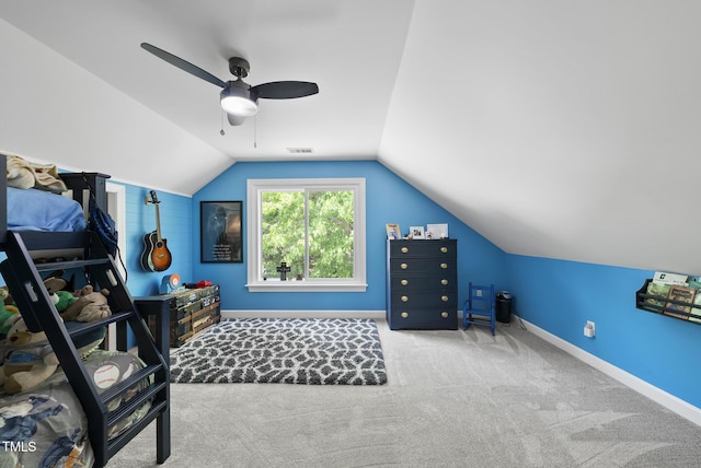 carpeted bedroom with visible vents, a ceiling fan, baseboards, and vaulted ceiling