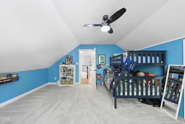 carpeted bedroom with baseboards, ceiling fan, and vaulted ceiling