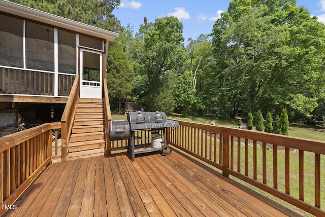 wooden deck with a sunroom, a yard, and stairway