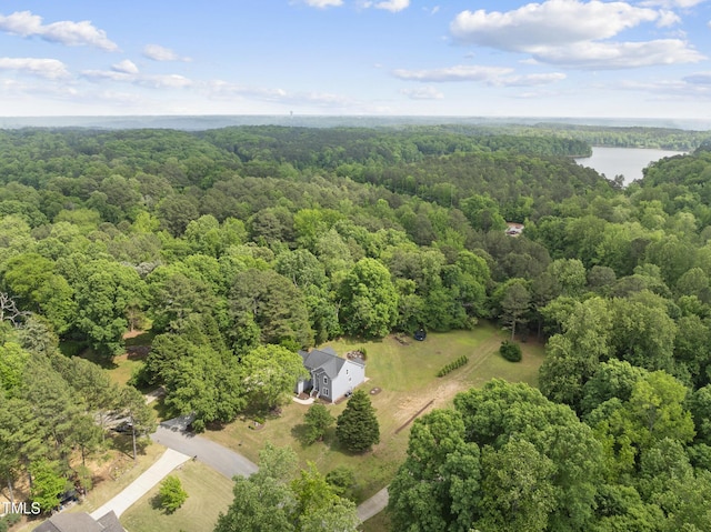 drone / aerial view with a water view and a wooded view