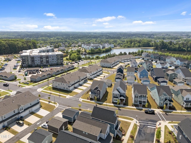 aerial view featuring a water view and a wooded view