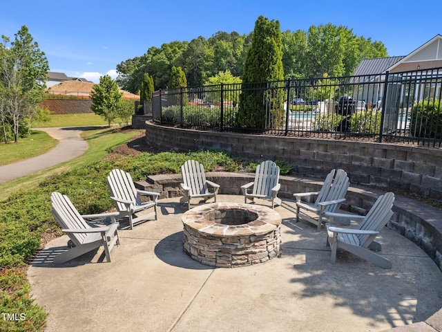 view of patio / terrace featuring fence and a fire pit