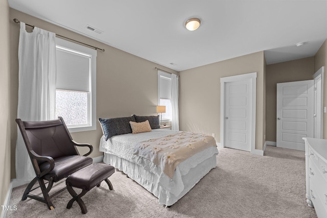bedroom with carpet floors, baseboards, and visible vents