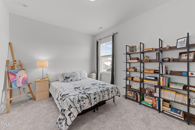 bedroom with visible vents and carpet