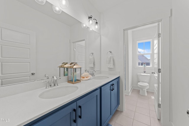 bathroom with tile patterned flooring, a sink, double vanity, and toilet