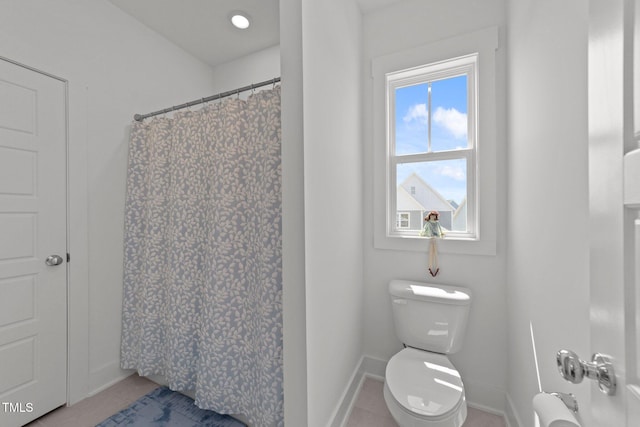 full bathroom with toilet, baseboards, a shower with curtain, and tile patterned flooring