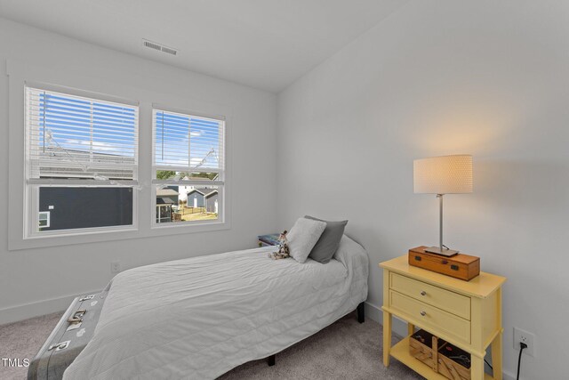 carpeted bedroom featuring baseboards and visible vents