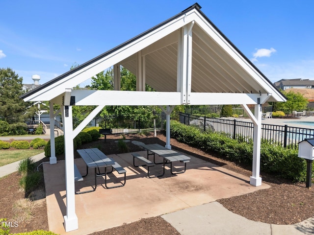 view of patio / terrace featuring fence, a community pool, and a gazebo