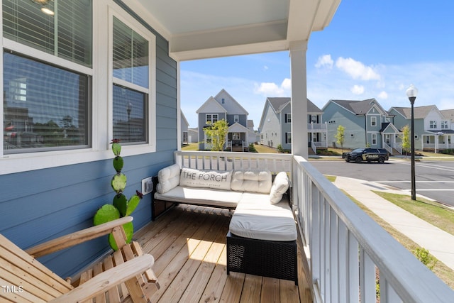 deck with a residential view and a porch