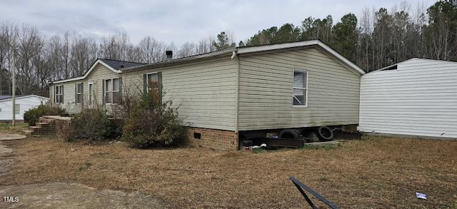 view of side of home with crawl space
