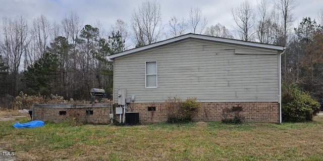 view of home's exterior with a yard, crawl space, and central AC